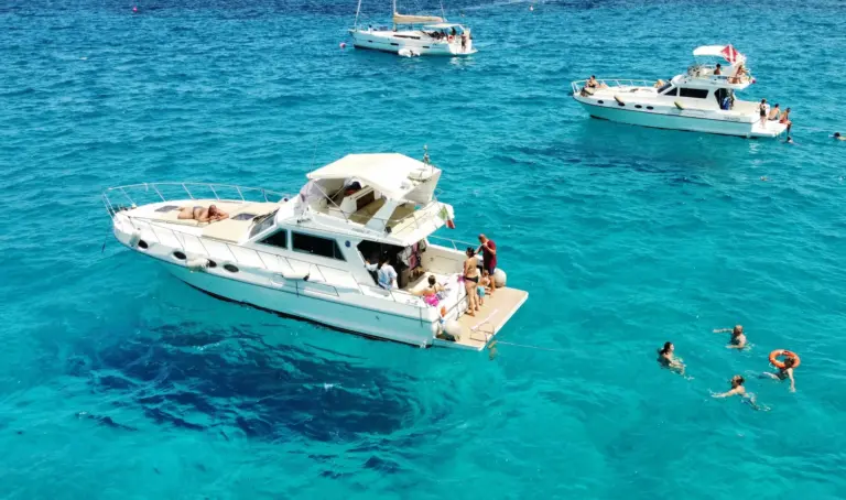 Piantoni 39 boat at anchor in turquoise water, guests swimming