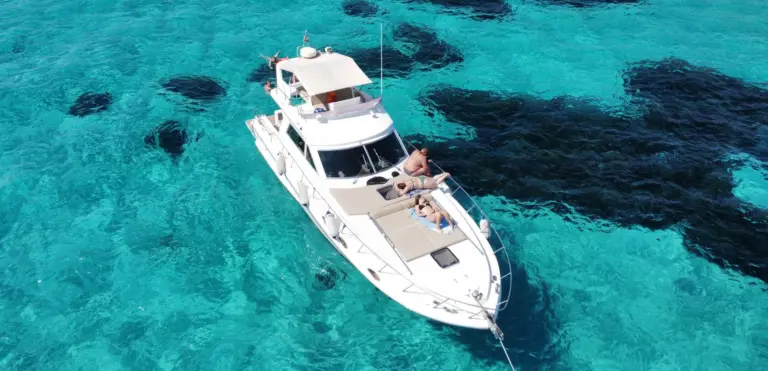 Helena dall'alto sulle chiazze di posidonia, ospiti sul prendisole di prua