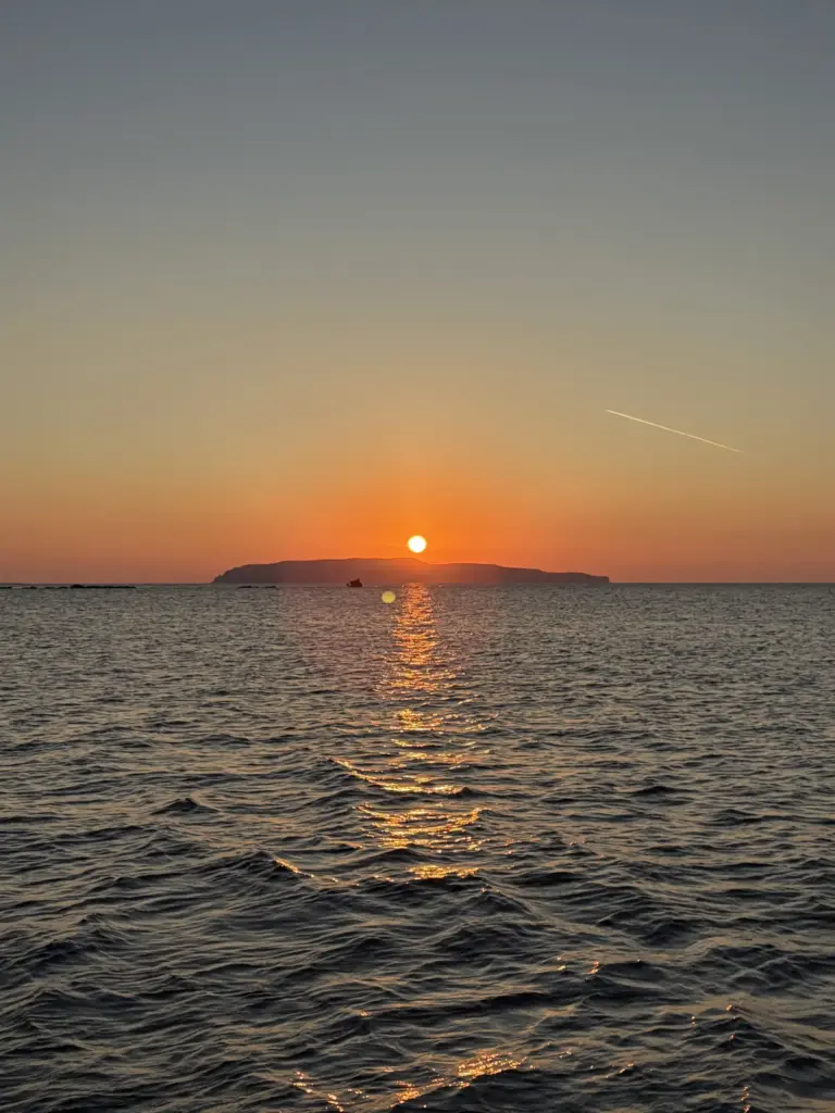 The sun setting behind one of the Egadi islands