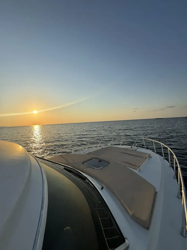 Sunset from the boat's bow, sun on the horizon